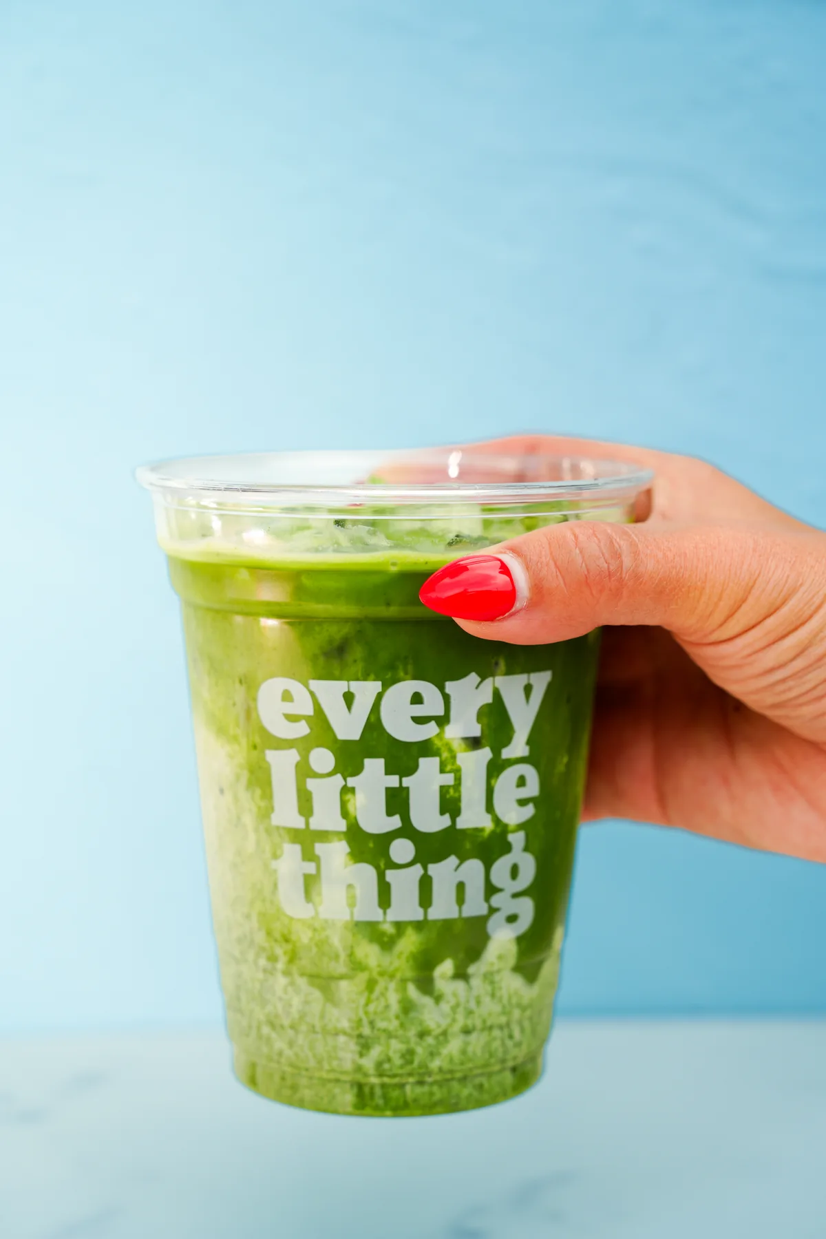 Green drink against a bright blue background
